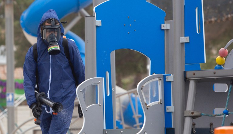 A worker sprays disinfectant as a precaution against the coronavirus in a playground in the central Israeli city of Bat Yam on Wednesday.