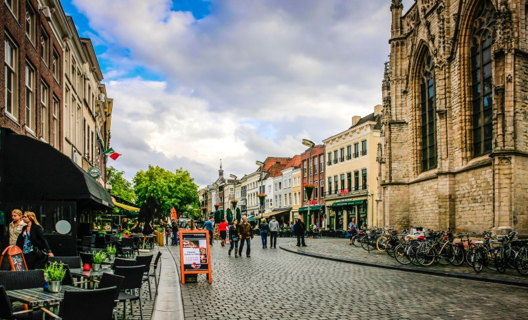 Church, commerce, people in Breda, Netherlands.