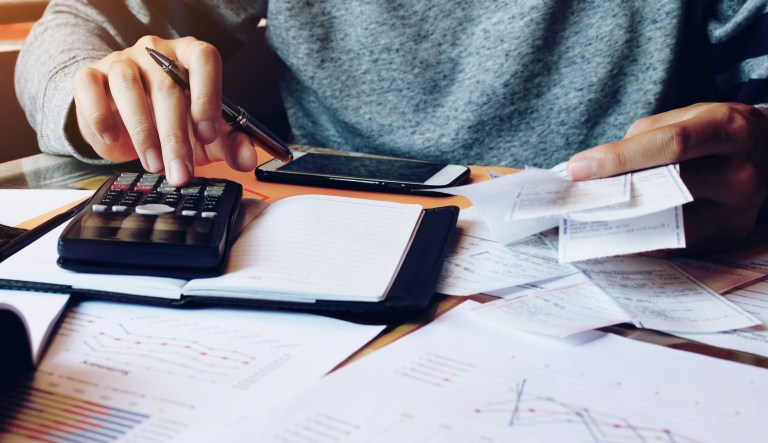A person calculates taxes.