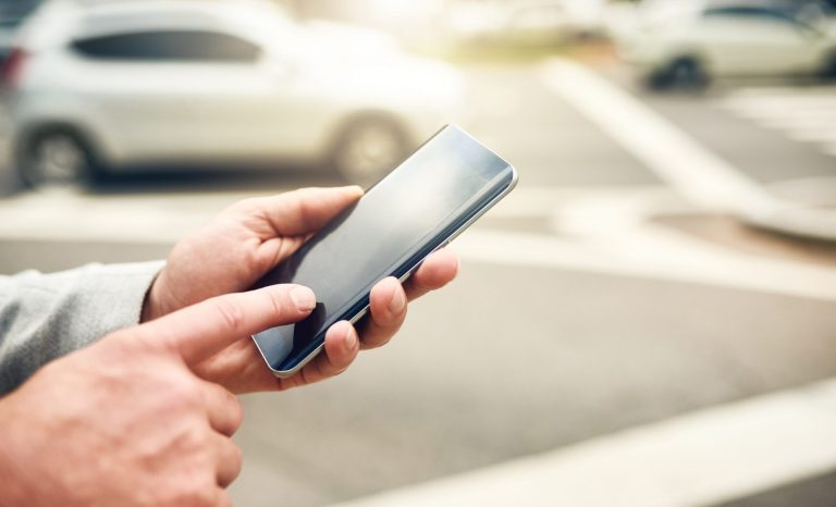 Closeup shot of a man using a cellphone.