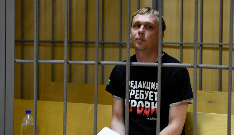 Ivan Golunov, a journalist who worked for the independent website Meduza, sits in a cage in a court room in Moscow, Russia, Saturday, June 8, 2019.