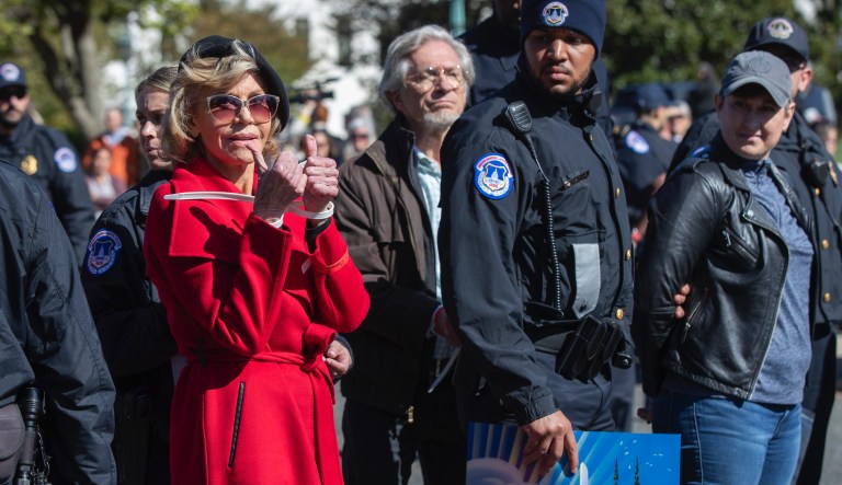 Actress Jane Fonda gestures after being arrested during a rally on Capitol Hill in Washington, Friday, Oct. 18, 2019. A half-century after throwing her attention-getting celebrity status into Vietnam War protests, 81-year-old Jane Fonda is now doing the same in a U.S. climate movement where the average age is 18.