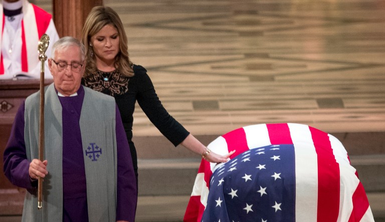 Jenna Bush Hager, the daughter of former President George Bush, touches the casket of former President George H.W. Bush after speaking at his State Funeral at the National Cathedral, Wednesday, Dec. 5, 2018, in Washington.