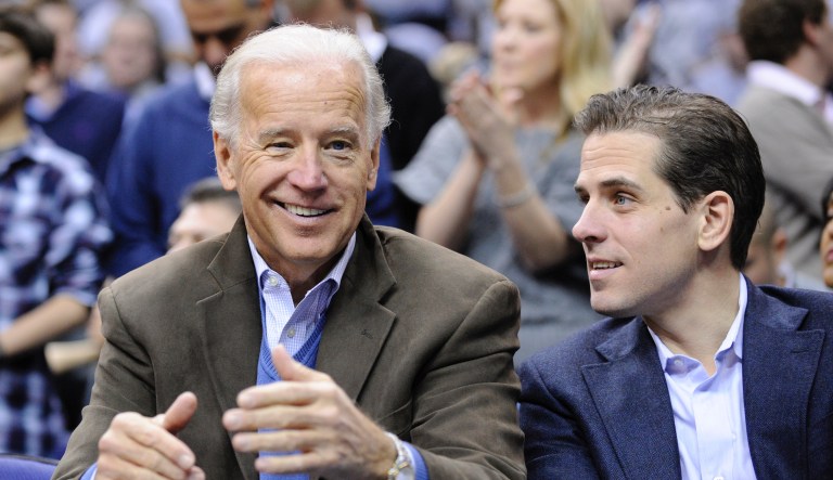 In this Jan. 30, 2010, file photo, Vice President Joe Biden, left, with his son, right, at the Duke Georgetown NCAA college basketball game in Washington.