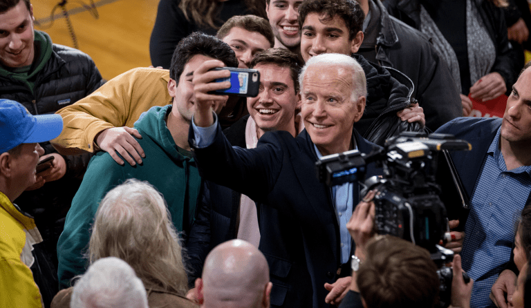 Democratic presidential candidate former Vice President Joe Biden takes a photograph with members of the audience as he speaks at a campaign stop at Roosevelt Creative Corridor Business Academy, Saturday, Feb. 1, 2020, in Cedar Rapids, Iowa. (AP Photo/Andrew Harnik)
