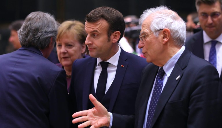 French President Emmanuel Macron, center, speaks with European Union foreign policy chief Josep Borrell, right, during a round table meeting at an EU summit in Brussels, Thursday, Feb. 20, 2020. After almost two years of sparring the EU will be discussing the bloc's budget, to work out Europe's spending plans for the next seven years.