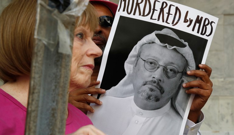 People hold signs during a protest at the Embassy of Saudi Arabia about the disappearance of Saudi journalist Jamal Khashoggi, Wednesday, Oct. 10, 2018, in Washington.