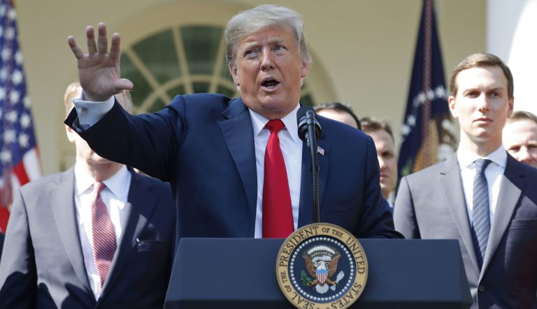 President Trump gestures as he answers questions from members of the media about Supreme Court nominee Judge Brett Kavanaugh in the Rose Garden of the White House in Washington, Monday, Oct. 1, 2018. Standing behind Trump is White House senior adviser Jared Kushner, right. 