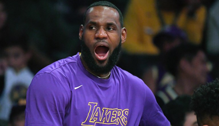 Los Angeles Lakers forward LeBron James yawns as he sits on the bench during the second half of a preseason NBA basketball game against the Golden State Warriors Monday, Oct. 14, 2019, in Los Angeles. 