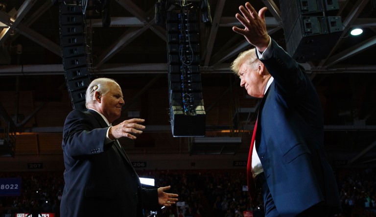 President Donald Trump opens his arms to Rush Limbaugh as he arrives to speaks during a rally at Show Me Center, Monday, Nov. 5, 2018, in Cape Girardeau, Mo.