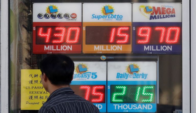 A sign displays the estimated Mega Millions jackpot at a convenience store in Chicago, Friday, Oct. 19, 2018. Friday's jackpot has soared to $1 billion, the second-largest prize in U.S. lottery history. 