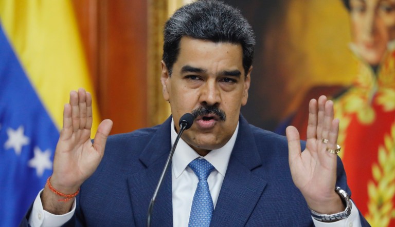 Venezuelan President Nicolas Maduro speaks to journalist during a press conference at Miraflores presidential palace in Caracas, Venezuela, Friday, Feb. 14, 2020. Venezuela is demanding that Washington stop piling on punishing financial sanctions aimed at forcing a regime change in Venezuela. The international court must next decide whether it will open an investigation. 
