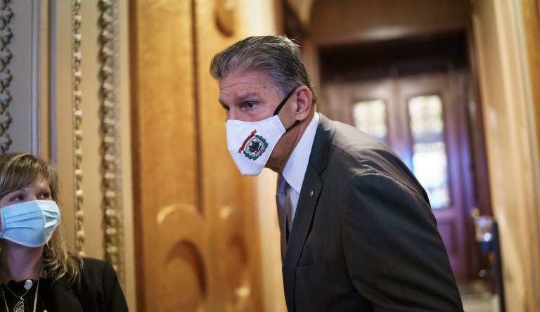 Sen. Joe Manchin (D-WV) walks to a caucus lunch at the Capitol in Washington, Dec. 17, 2021. 