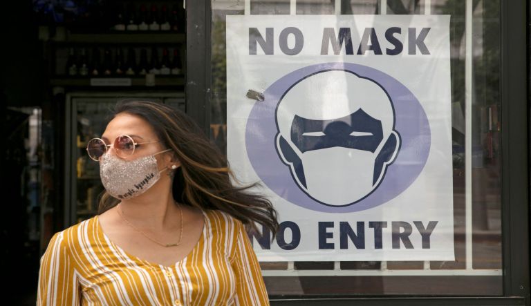 People queue up to buy face masks at a cosmetics shop in Hong Kong, Friday, Jan. 31, 2020. 