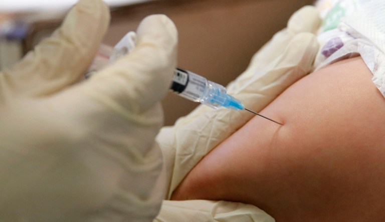Rambo Islas, 8 months, is held by his mother Maria Islas, as he gets a shot for a vaccine administered by RN, Nicole Ives at the Dallas County Health & Human Services immunization clinic in Dallas on Friday, March 8, 2019.
