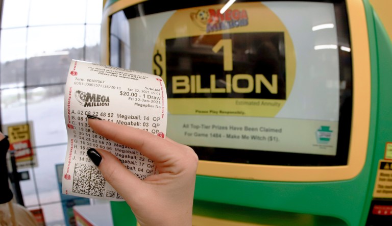 A patron, who did not want to give her name, shows the ticket she had just bought for the Mega Millions lottery drawing at the lottery ticket vending kiosk in a Smoker Friendly store, Friday, Jan. 22, 2021, in Cranberry Township, Pa. The jackpot for the Mega Millions lottery game has grown to $1 billion ahead of Friday nightâs drawing after more than four months without a winner.