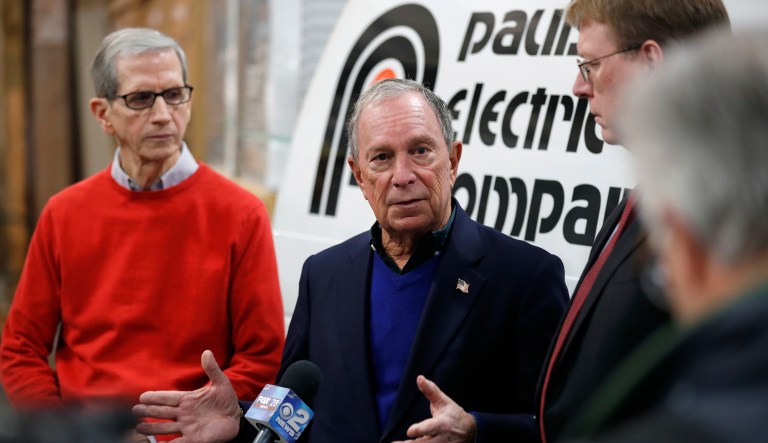 Former New York City Mayor Michael Bloomberg, center, speaks during a news conference after touring the Paulson Electric Company, Tuesday, Dec. 4, 2018, in Cedar Rapids, Iowa.