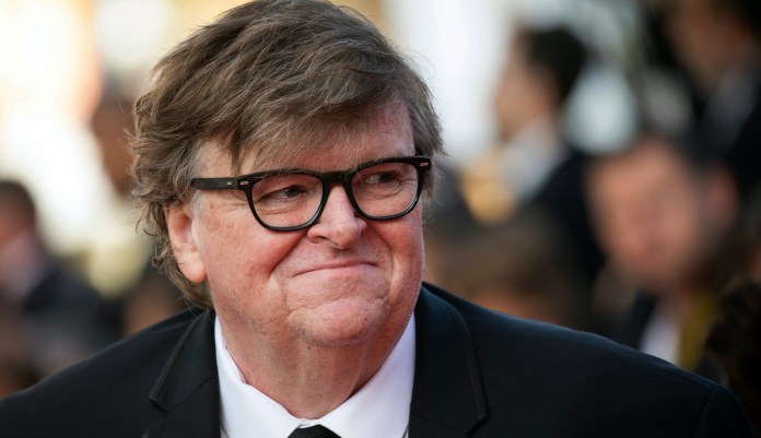Michael Moore poses for photographers upon arrival at the awards ceremony of the 72nd international film festival, Cannes, southern France, Saturday, May 25, 2019.