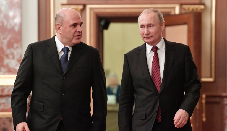 In this file photo taken on Tuesday, Jan. 21, 2020, Russian President Vladimir Putin, right, and new Russian Prime Minister Mikhail Mishustin talk as they arrive to attend a new cabinet meeting in Moscow, Russia.