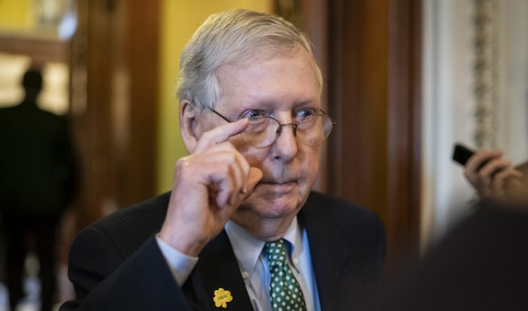 Senate Majority Leader Mitch McConnell, R-Ky., walks through a crowd of reporters after announcing he has canceled the Senate recess next week, at the Capitol in Washington, Thursday, March 12, 2020. The Republican-controlled Senate and Democrat-controlled House have not yet agreed on terms of a coronavirus aid package. 