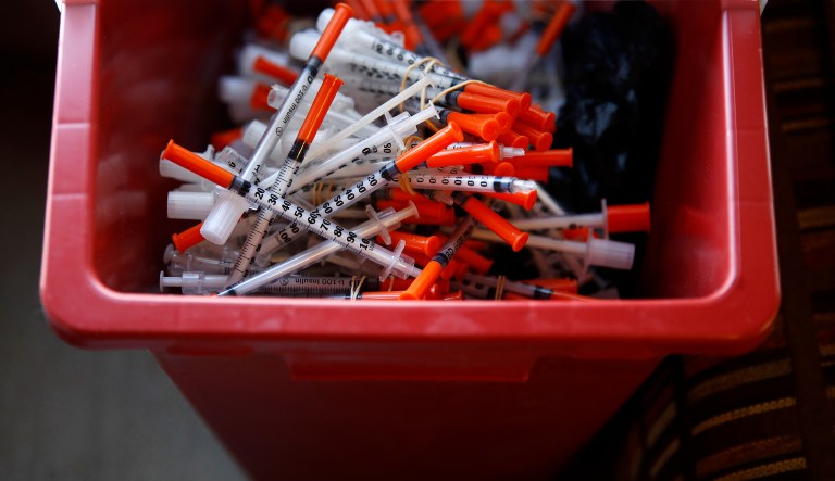In this Jan. 18, 2018 photo, used needles sit in a container inside the Baltimore City Health Department's Needle Exchange Team van in Baltimore. 