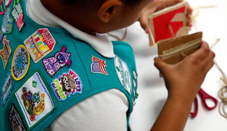 In this July 21, 2017 photo, badges are seen on the vest of a member of the Girl Scouts of Central Maryland as she participates in an activity introducing the world of robotics in Owings Mills, Md. The Girl Scouts of the USA is unveiling a major push this week into furthering the interest of girls in science, engineering, technology and math through 23 new badges, its largest addition of new badges in a decade.