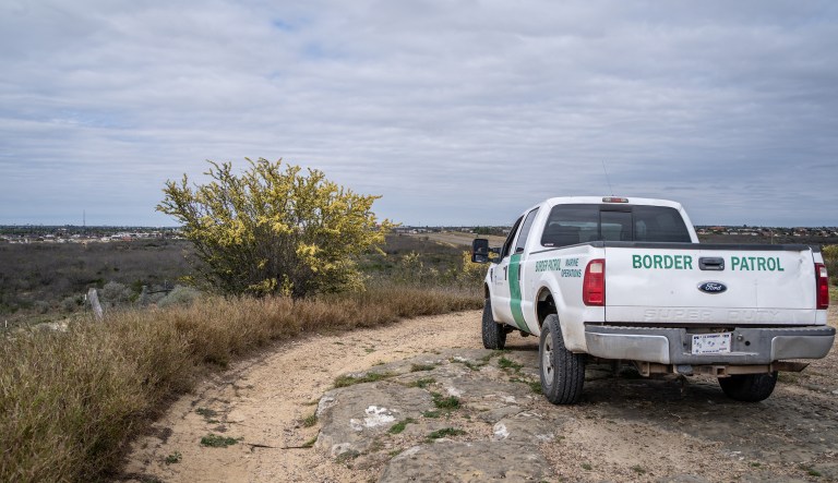 A U.S. Border Patrol vehicle sits parked near the border between the United States and Mexico.