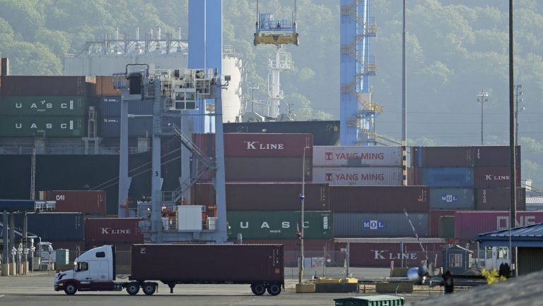 A truck drives near cargo containers, Friday, May 10, 2019, at the Port of Tacoma in Tacoma, Wash. U.S. and Chinese negotiators resumed trade talks Friday under increasing pressure after President Donald Trump raised tariffs on $200 billion in Chinese goods and Beijing promised to retaliate. 