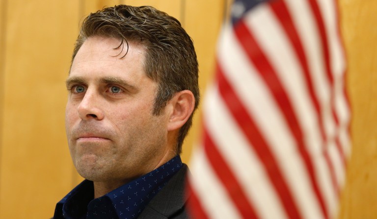 In this Tuesday, Oct. 15, 2019 photo, Virginia Del. Nick Freitas listens to an introduction during a town hall in Lake of Woods, Va. Freitas is running a write in campaign after a paperwork error left his off the November ballot.