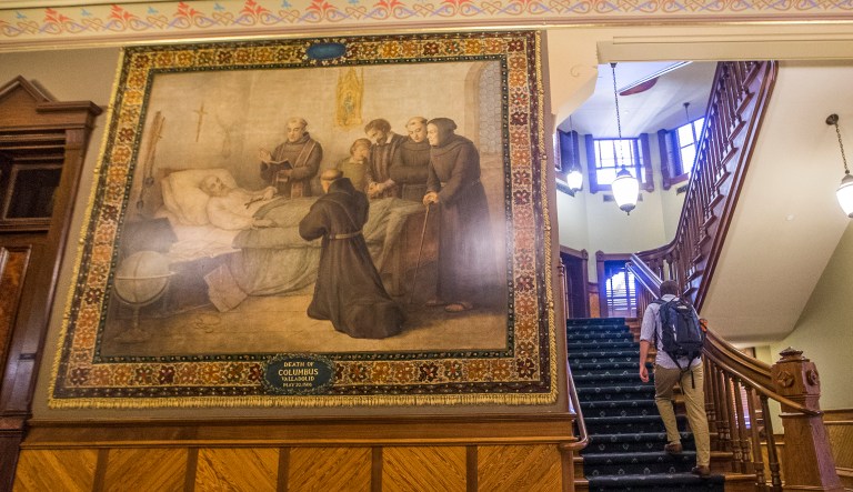 This Nov. 29, 2017, photo shows a murals of Christopher Columbus at Notre Dame in South Bend, Ind. The University of Notre Dame will cover murals in a campus building that depict Christopher Columbus in America, the school's president said, following criticism that the images depict Native Americans in stereotypical submissive poses before white European explorers.