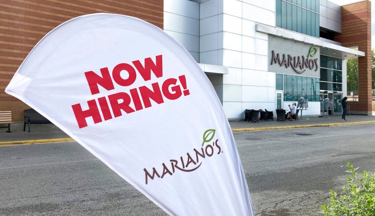A now hiring sign is seen in front of a business along the boardwalk, Thursday, June 2, 2022, in Ocean City, New Jersey. Many seasonal businesses are struggling to find enough workers again this summer.