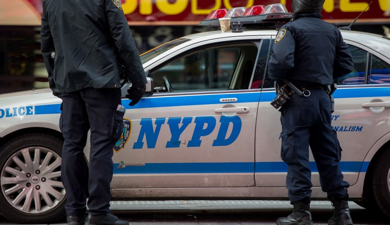 New York Police Department (NYPD) officers stand on patrol in the Times Square area of New York, U.S., on Monday, Jan. 5, 2015.