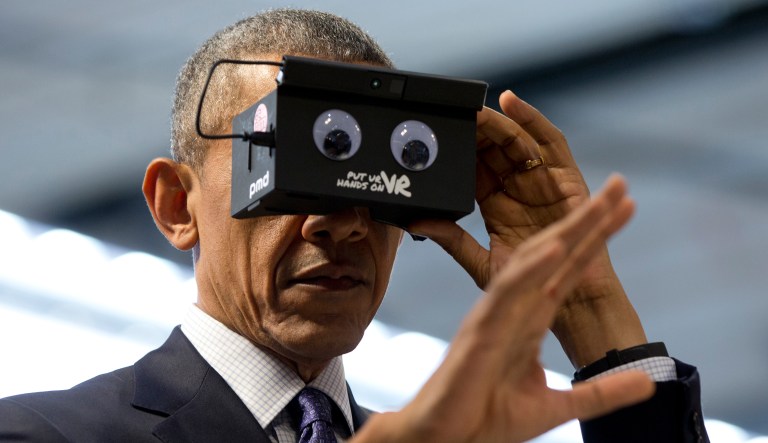U.S. President Barack Obama looks at his hand as he tests VR goggles when touring the Hannover Messe, the world's largest industrial technology trade fair, in Hannover, northern Germany, Monday, April 25, 2016. Obama is on a two-day official visit to Germany.