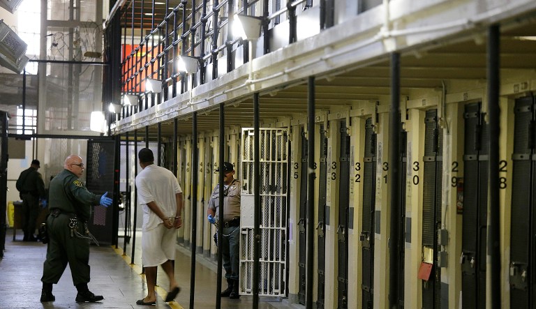 FILE - In this Aug. 16, 2016 file photo, a condemned inmate is led out of his east block cell on death row at San Quentin State Prison in San Quentin, Calif.