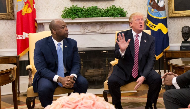 President Donald Trump, with Sen. Tim Scott, R-S.C., second from left, and Ivanka Trump, top right, participate in a working session regarding the opportunity zones provided by tax reform in the Oval Office of the White House, Wednesday, Feb. 14, 2018, in Washington.