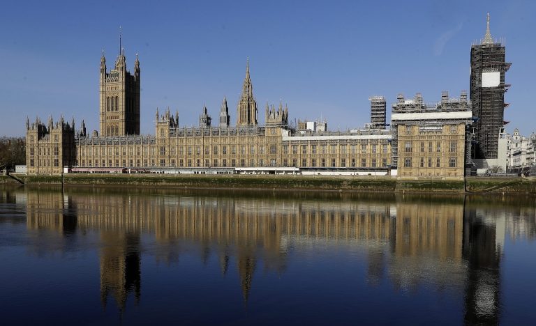 The Palace of Westminster is reflected in the river Thames opposite St Thomas' Hospital in central London.