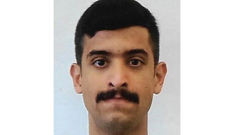 Police cars escort an ambulance after a shooter open fire inside the Pensacola Air Base, Friday, Dec. 6, 2019 in Pensacola, Fla.