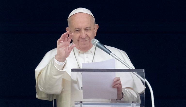 Faithful watch Pope Francis deliver the Angelus prayer on a giant screen, in St. Peter's Square, at the Vatican, Sunday, March 8, 2020. Italy's Prime Minister Giuseppe Conte announced a sweeping coronavirus quarantine early Sunday, restricting the movements of about a quarter of the country's population in a bid to limit contagions at the epicenter of Europe's outbreak.