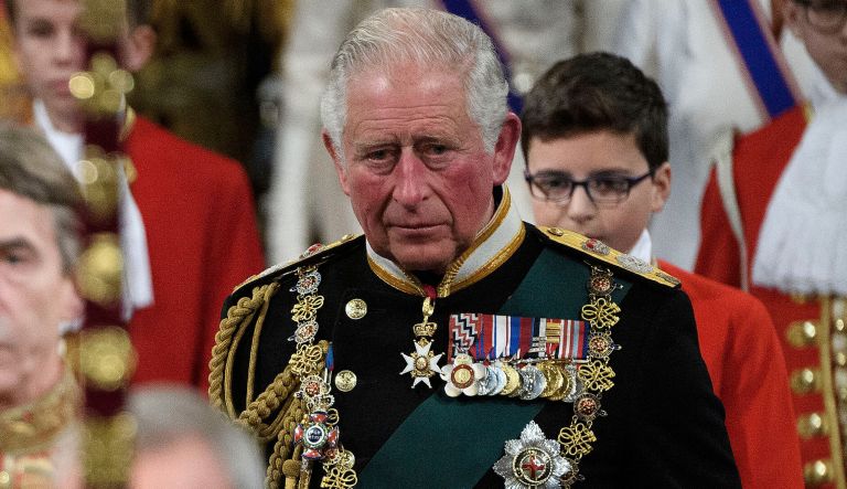 Queen Elizabeth II, accompanied by the Prince of Wales, proceed through the Royal Gallery before delivering the Queen's Speech during the State Opening of Parliament in the House of Lords at the Palace of Westminster in London. PA Photo. Picture date: Monday October 14, 2019. See PA story POLITICS Speech                                                                                    
