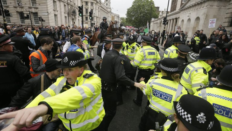 Police forces are trying to restore order after a small scuffle broke out between Donald Trump supporters and people that gathered in central London to demonstrate against the state visit of President Donald Trump, Tuesday, June 4, 2019. Trump will turn from pageantry to policy Tuesday as he joins British Prime Minister Theresa May for a day of talks likely to highlight fresh uncertainty in the allies' storied relationship. 