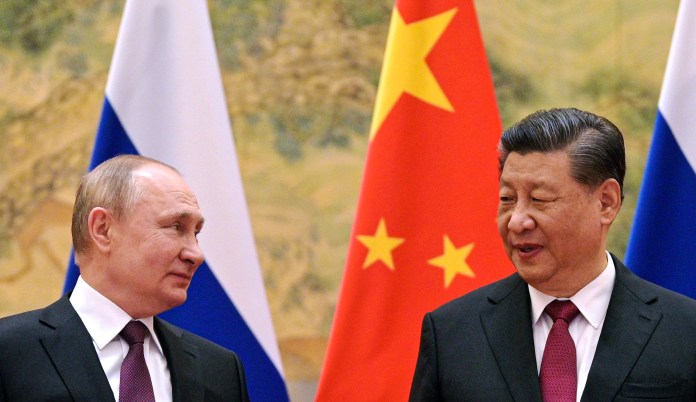 Chinese President Xi Jinping, right, and Russian President Vladimir Putin talk to each other during their meeting in Beijing, China, Friday, Feb. 4, 2022. Russian President Vladimir Putin is in Beijing for the Winter Olympics and talks with his Chinese counterpart Xi Jinping, amid soaring tensions with Ukraine. 
