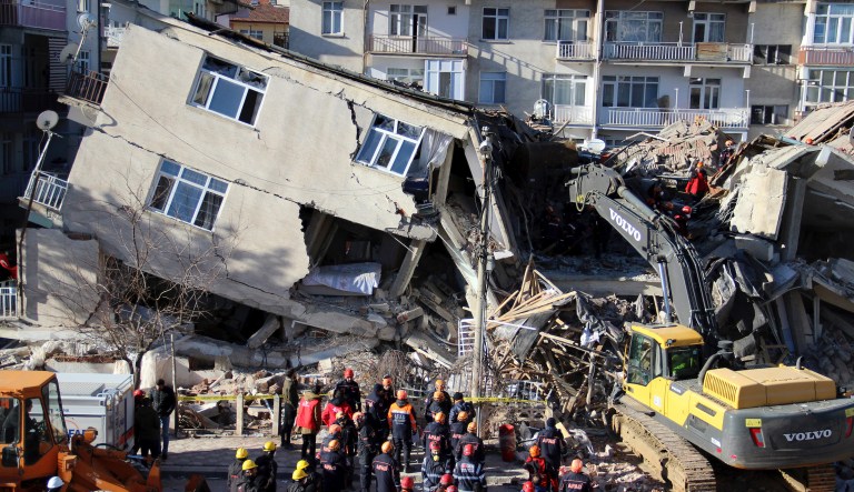 Rescue workers on a collapsed building after a 6.8 earthquake struck in Elazig in the eastern Turkey, Saturday, Jan. 25, 2020. An earthquake with a preliminary magnitude of 6.8 rocked eastern Turkey on Friday, causing some buildings to collapse and killing at least 22 people, Turkish officials said.