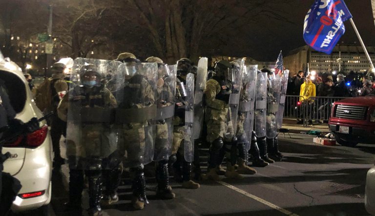Authorities stand shoulder-to-shoulder as they work to push a mob of pro-Trump demonstrators from the Capitol complex on Thursday, Jan. 6, 2021.