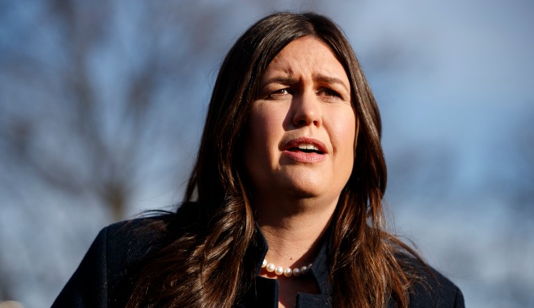 White House press secretary Sarah Huckabee Sanders talks with reporters outside the White House, Friday, Jan. 25, 2019, in Washington.