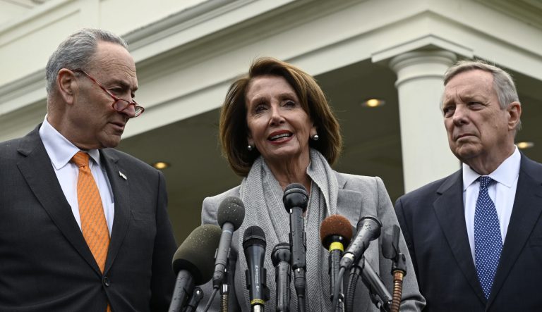House Speaker Nancy Pelosi of Calif., center, standing with Senate Minority Leader Sen. Chuck Schumer of N.Y., left, and Sen. Dick Durbin, D-Ill., right, speak with reporters following their meeting with President Donald Trump at the White House in Washington, Wednesday, Jan. 9, 2019. 