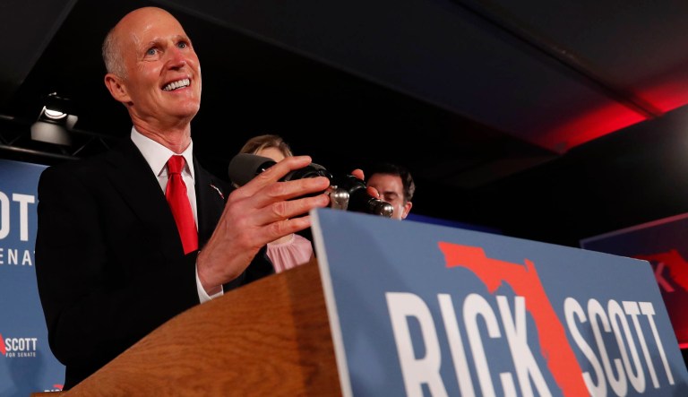 Republican Senate candidate Rick Scott smiles as he speaks to supporters at an election watch party, Wednesday, Nov. 7, 2018, in Naples, Fla.