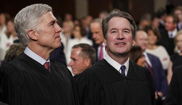 Supreme Court Associate Justices Neil Gorsuch, left, and Brett Kavanaugh watch as President Trump arrives to give his State of the Union address to a joint session of Congress at the Capitol, Tuesday, Feb. 5, 2019 in Washington. 
