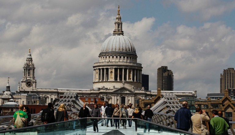 Pedestrians walk across the Millenium Bridge in front of St Paul's Cathedral in London, Thursday, June 16, 2011. The cathedral is seen without scaffolding for the first time in 15 years, as a cleaning and restoration project costing 40 million pounds (US$ 64.37million. euro 45.69 million). It is the first time in its history that the building has been comprehensively restored inside and out since its completion in 1711.