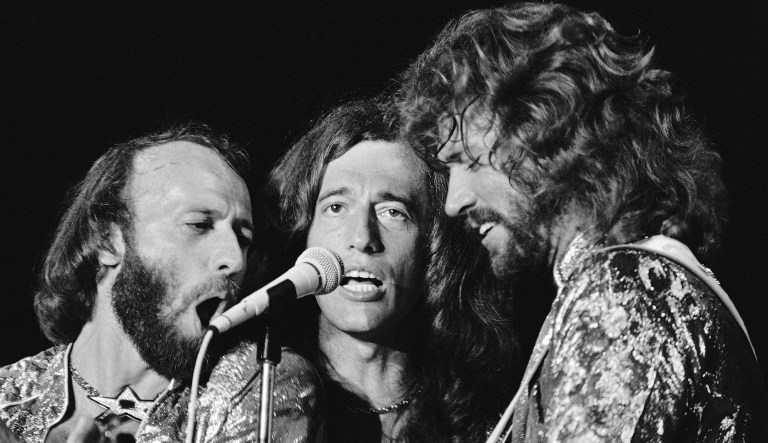 In this Nov. 6, 1979 file photo, The Bee Gees, from left, Maurice, Robin and Barry Gibb perform in Miami Beach, Fla. Doctors have revived the old disco song "Stayin' Alive" and found that it might actually live up to its name.  At 103 beats per minute, the Bee Gees' sung-in-falsetto tune has almost the perfect rhythm to help jump-start a stopped heart. 