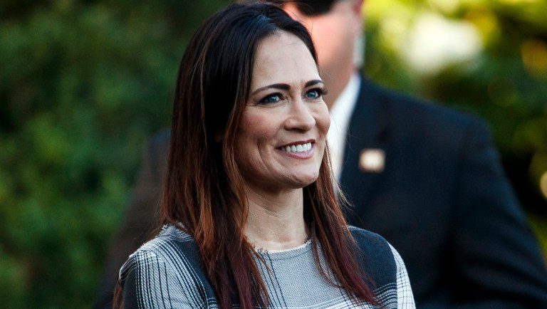 In this June 21, 2019 photo, Stephanie Grisham, spokeswoman for first lady Melania Trump, watches as President Donald Trump and the first lady greet attendees during the annual Congressional Picnic on the South Lawn in Washington. First lady Melania Trump has announced that Grisham will be the new White House press secretary. Grisham, who has been with President Donald Trump since 2015, will also take on the role of White House communications director. 